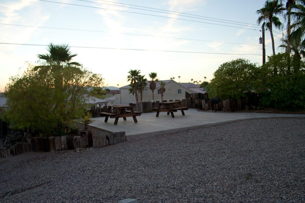 Shared courtyard with picnic tables and BBQ at dusk